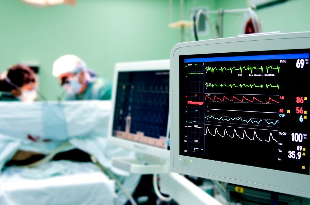 Cardiologist monitors heart rate during cardiac procedure.